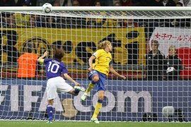 Homare Sawa (L) scores the second goal for Japan