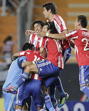 Paraguay players celebrate after beating Brazil in a penalty shootout in their quarter-final soccer match at the Copa America in La Plata on Sunday