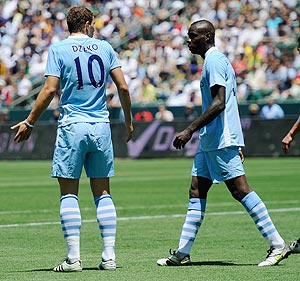 Manchester City's Edin Dzeko has words with teammate Mario Balotelli after the latter blasted the ball into the net he inexplicably tried to score with a spinning backheel which went wide of the target against the Los Angeles Galaxy on Sunday