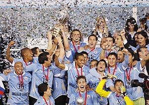 Uruguay players and officials celebrate winning the Copa America final against Paraguay in Buenos Aires on Sunday