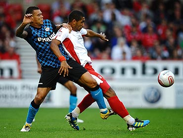 Lewis McGugan Nottingham Forest (right) battles for the ball with Wilfred Bouma of PSV during their pre-season friendly at City Ground on Wednesday
