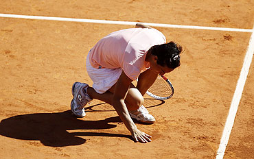 Francesca Schiavone picks up some clay after defeating Marion Bartoli