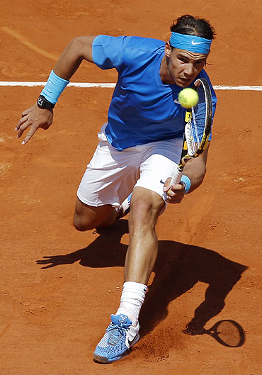 Rafael Nadal plays a return