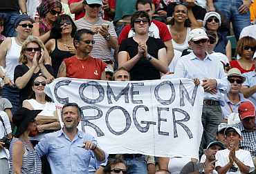 A supporter of Roger Federer holds a banner during the men's final at the French Open