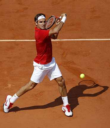 Roger Federer returns during the men's final match against Rafa Nadal at the French Open