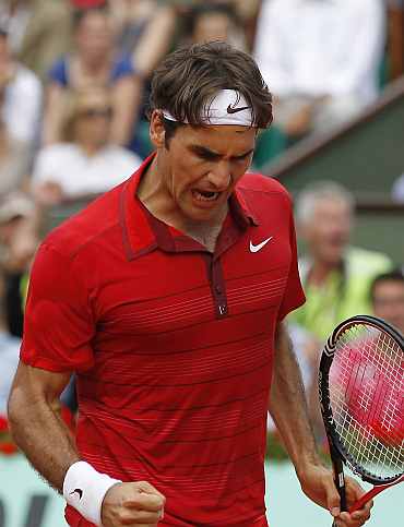 Roger Federer reacts after winning the third set during his men's final against Rafa Nadal at the French Open