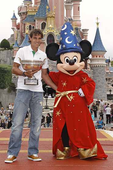 Rafael Nadal poses for photos at the Disneyland Resort in Marne-la-Vallee outside Paris