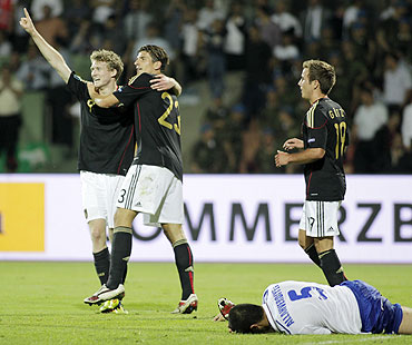 Germany's Mario Gomez (2nd from left) and Andre Schurrle (left) celebrate their victory over  Azerbaijan