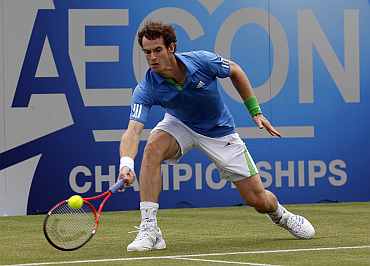 Andy Murray returns during his practice match against Xavier Mallise at Queens club championships