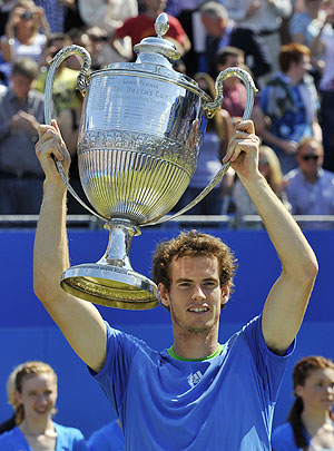 Andy Murray of Britain holds up The Queen's Cup trophy