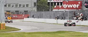 McLaren's Jenson Button (right) pulls away from Red Bull's Sebastian Vettel to win the Canadian F1 Grand Prix at the Circuit Gilles Villeneuve on Sunday