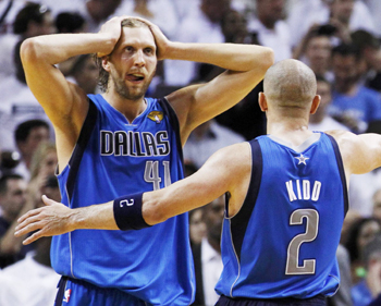 Dallas Mavericks' Dirk Nowitzki (L) celebrates with teammate Jason Kidd near the end of Game 6 of the NBA Finals basketball series against the Miami Heat in Miami