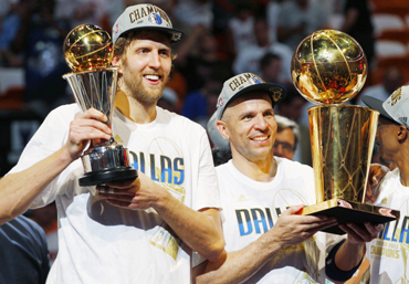 Mavericks' Nowitzki holds the Bill Russell NBA Finals MVP trophy as Kidd holds the Larry O'Brien Championship Trophy