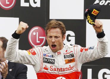 McLaren Formula One driver Jenson Button of Britain celebrates winning the Canadian F1 Grand Prix on the podium at the Circuit Gilles Villeneuve in Montreal