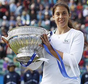 France's Marion Bartoli celebrates with the trophy after beating Czech Republic's Petra Kvitova