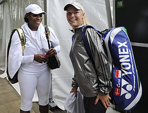 Serena Williams of the US (left) and Caroline Wozniacki of Denmark have a chat following a practice session at Wimbledon in London on Saturday