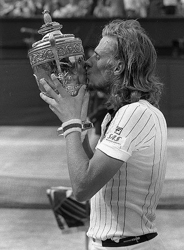Bjorn Borg kisses the trophy after beating Ilie Nastase 6-4, 6-2, 9-7 to become Wimbledon champion in 1976