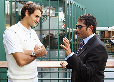 Roger Federer chats with Sachin Tendulkar at Wimbledon on Saturday
