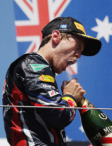 Red Bull'S Sebastian Vettel celebrates on the podium after winning the European Formula One Grand Prix on Sunday