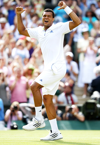 Jo-Wilfried Tsonga of France celebrates after winning his quarterfinal round match against Roger Federer of Switzerland on Day Nine of the Wimbledon