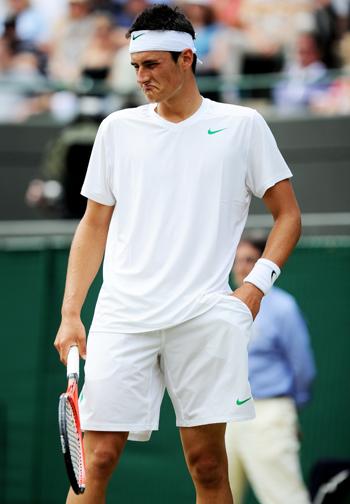 Bernard Tomic of Australia reacts to a play during his quarterfinal round match against Novak Djokovic of Serbia on Day Nine of the Wimbledon