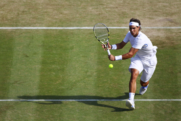 Rafael Nadal of Spain returns a shot during his quaterfinal round match against Mardy Fish of the United States