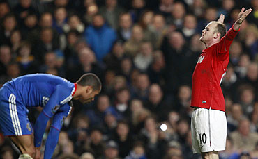 Manchester United's Wayne Rooney (right) celebrates after scoring as Chelsea's Ashley Cole reacts