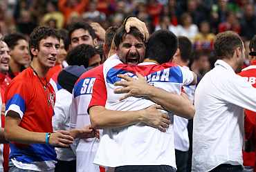 Serbian team celebrates after winning their Davis Cup tie