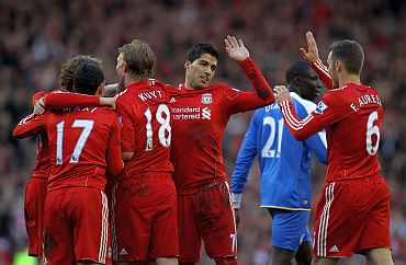 Liverpool players celebrate after scoring a goal