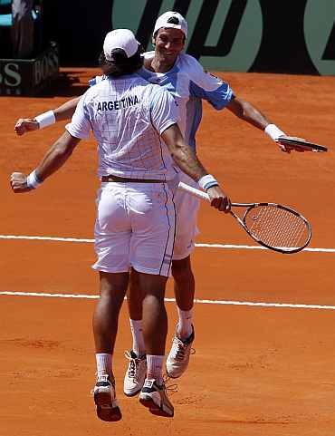 Argentina's Eduardo Schwank (L) and Juan Ignacio Chela celebrate after winning their Davis Cup double match