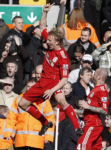 Liverpool's Dirk Kuyt (left) celebrates scoring his second goal against Manchester United on Sunday