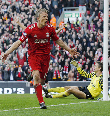 Liverpool's Dirk Kuyt (left) celebrates his third goal against Manchester United