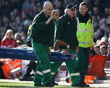 Manchester United's Nani is stretchered off after his tackle with Liverpool's Jamie Carrigher