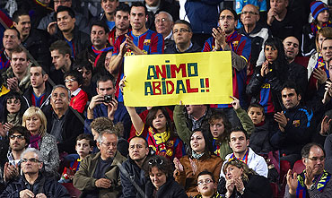 Barcelona fans display a banner in support of Eric Abidal before the match against Getafe on Saturday