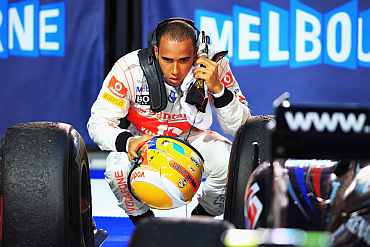 Lewis Hamilton checks his car after the race
