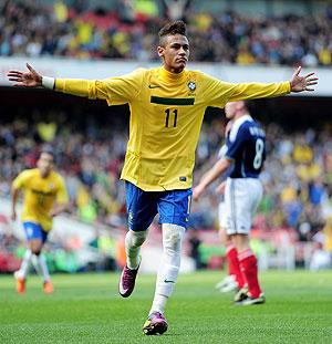 Neymar celebrates scoring his opening goal against Scotland