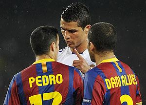 Real Madrid's Cristiano Ronaldo (centre) argues with Bracelona's Pedro Rodriguez (left) and Dani Alves