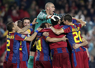 Barcelona players celebrate after qualifying for the Champions League final