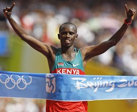 Samuel Wanjiru crosses the finish line first at the Beijing Olympics