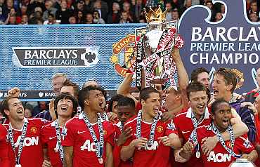Manchester United players celebrate after winning the Premier League title