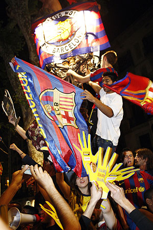 Barcelona's supporters celebrate their victory against Manchester United in front of Canaletas fountain at Las Ramblas in central Barcelona
