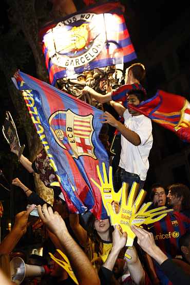 Barcelona fans celebrate after their team beat Manchester United to win Champions League