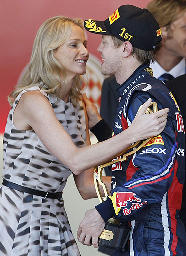 Red Bull Formula One driver Sebastian Vettel of Germany (right) is congratulated by Charlene Wittstock, the fiancee of Prince Albert II of Monaco, after he won the Monaco F1 Grand Prix
