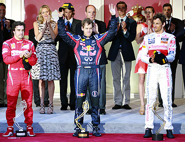 Red Bull's Sebastian Vettel (centre) celebrates on the podium with Ferarri's Fernando Alonso and McLaren's Jenson Button
