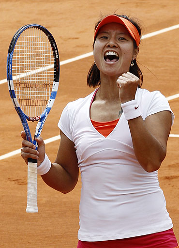 Li Na reacts after winning her match against Petra Kvitova