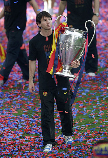 Barcelona's Lionel Messi holds the Champions League trophy at Camp Nou stadium in Barcelona