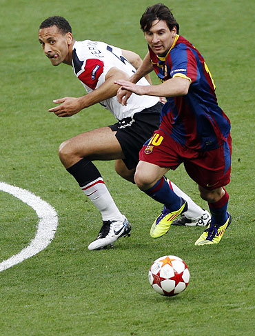 Manchester United's Rio Ferdinand (left) and Barcelona's Lionel Messi vie for possession