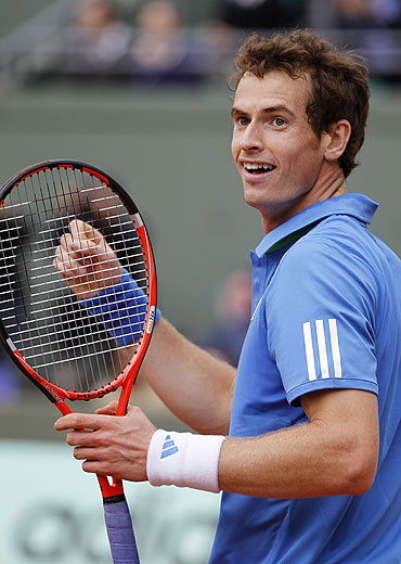 Andy Murray reacts after winning his match against Viktor Troicki