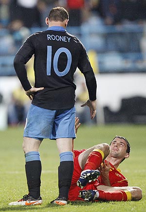 Montenegro's Miodrag Dzudovic (right) reacts after a challenge by England's Wayne Rooney who was sent off during their Euro 2012 qualifier