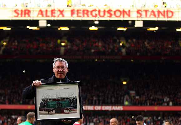 Sir Alex Ferguson is presented with a photo to commemerate his 25th year as manager, as the North Stand is renamed the 'Sir Alex Ferguson Stand'
